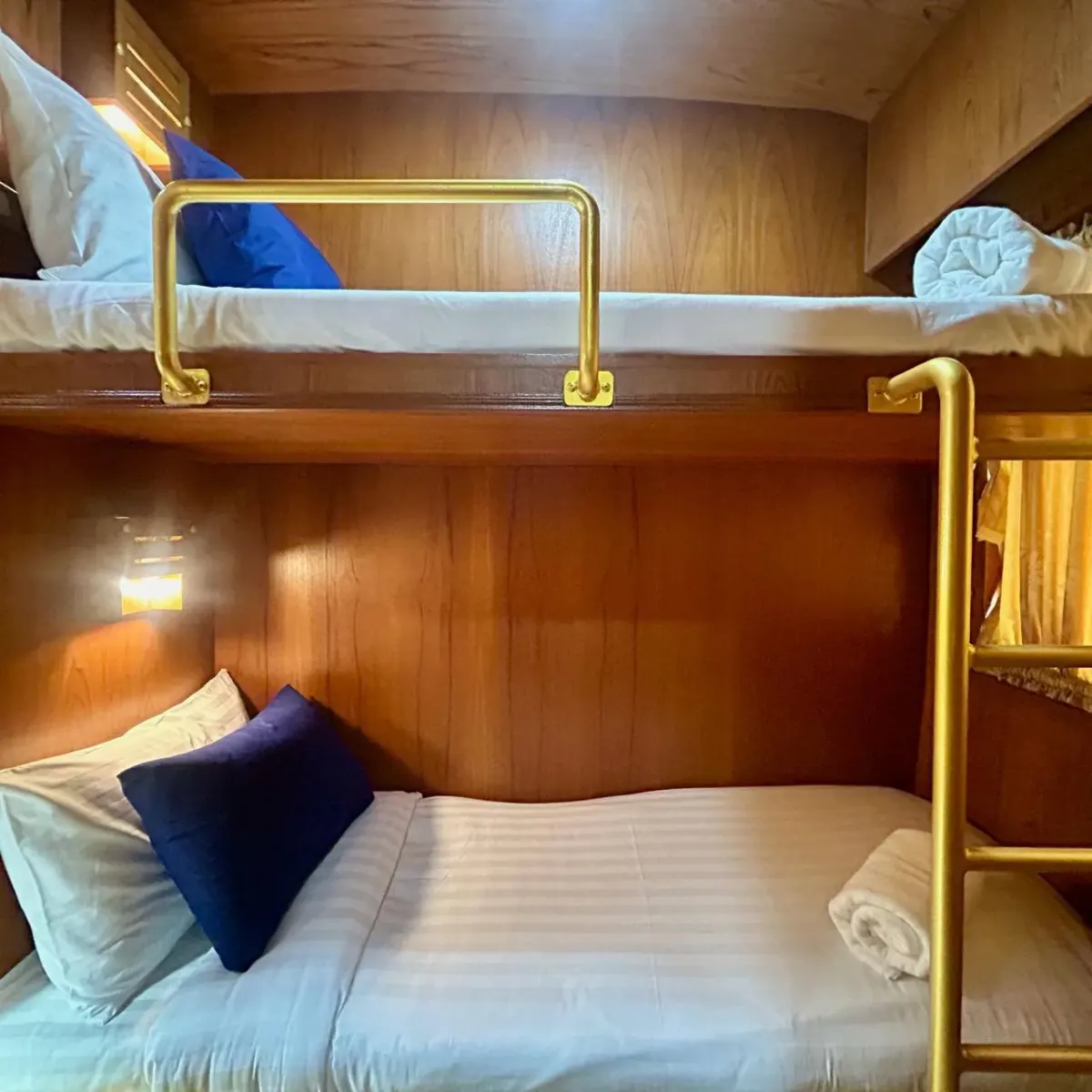 Cozy bunk bed cabin interior with brass rails and wood paneling, used as a decorative hero image for a FATCA Form 8938 explainer page Cozy bunk bed cabin interior with brass rails and wood paneling, used as a decorative hero image for a FATCA Form 8938 explainer page